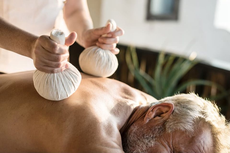 Gentle herbal poultice therapy for an elderly client